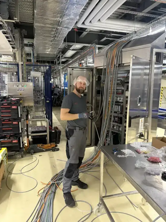 Technicien électricien VLD Service travaillant sur une armoire électrique industrielle